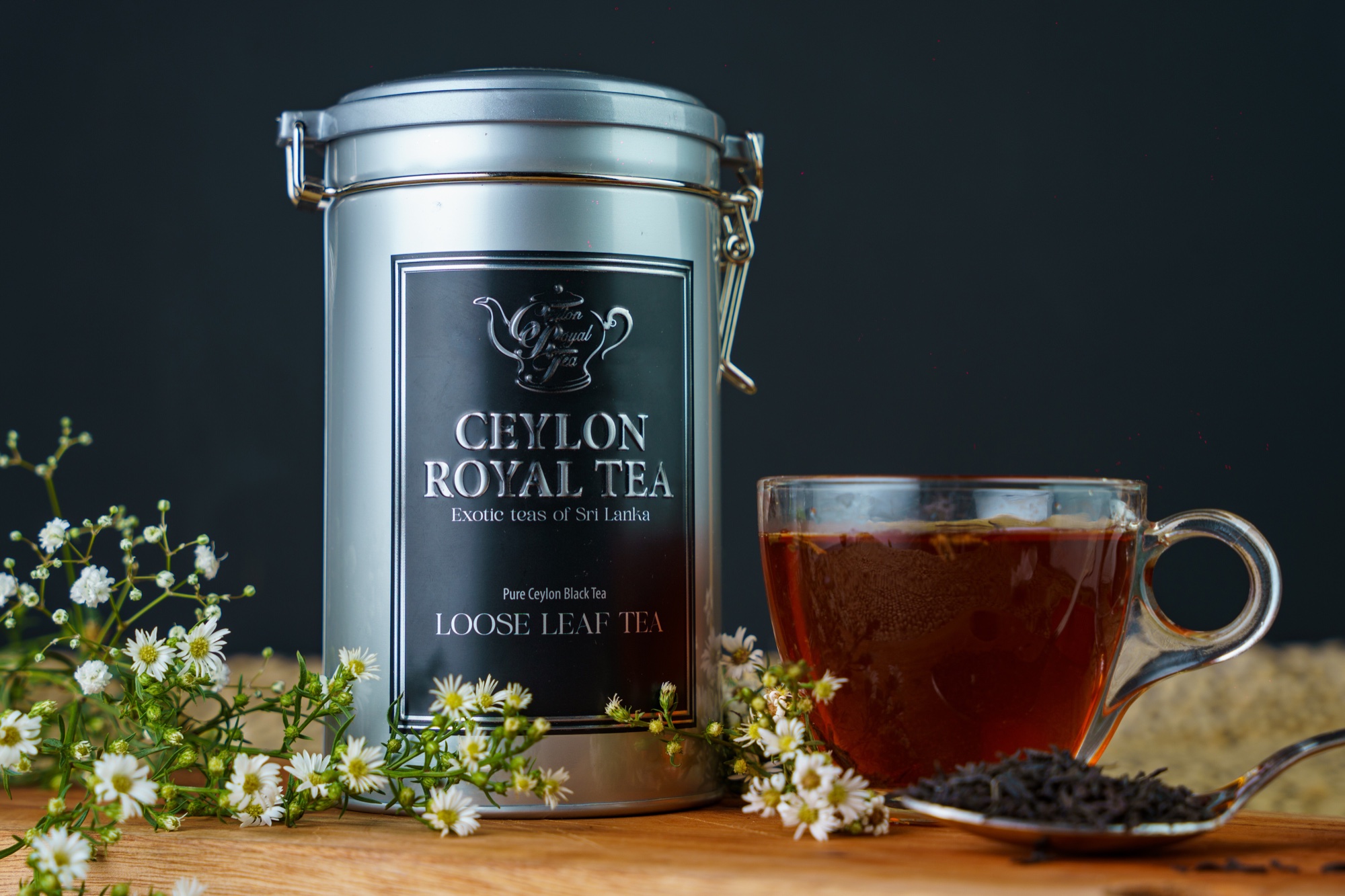 Ceylon Royal Tea loose leaf tea tin with fresh flowers and a cup of black tea
